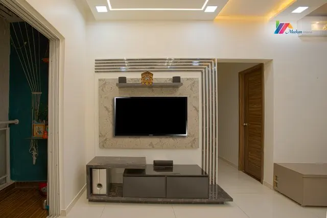 A television wall with layered trim and a low media cabinet.