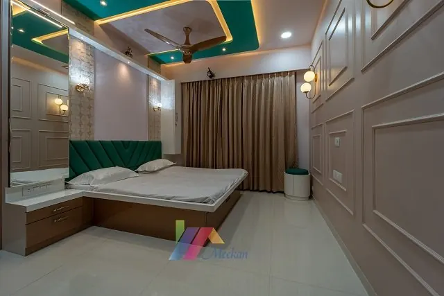 Bedroom with a timber bed, green headboard and fitted wardrobes.