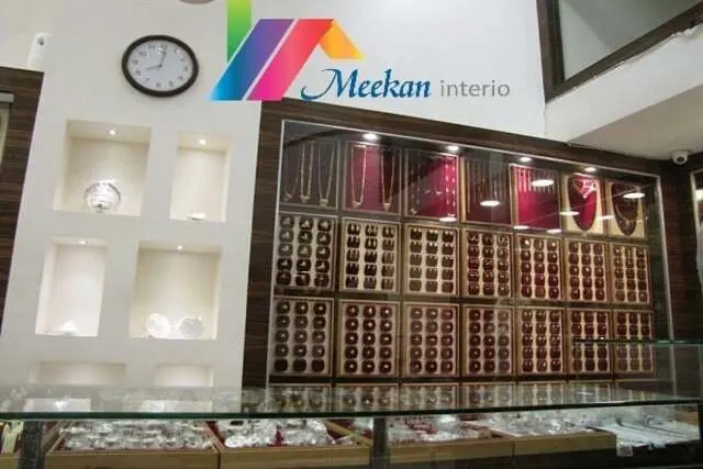 A jewellery shop display wall with recessed shelves and glass counters.
