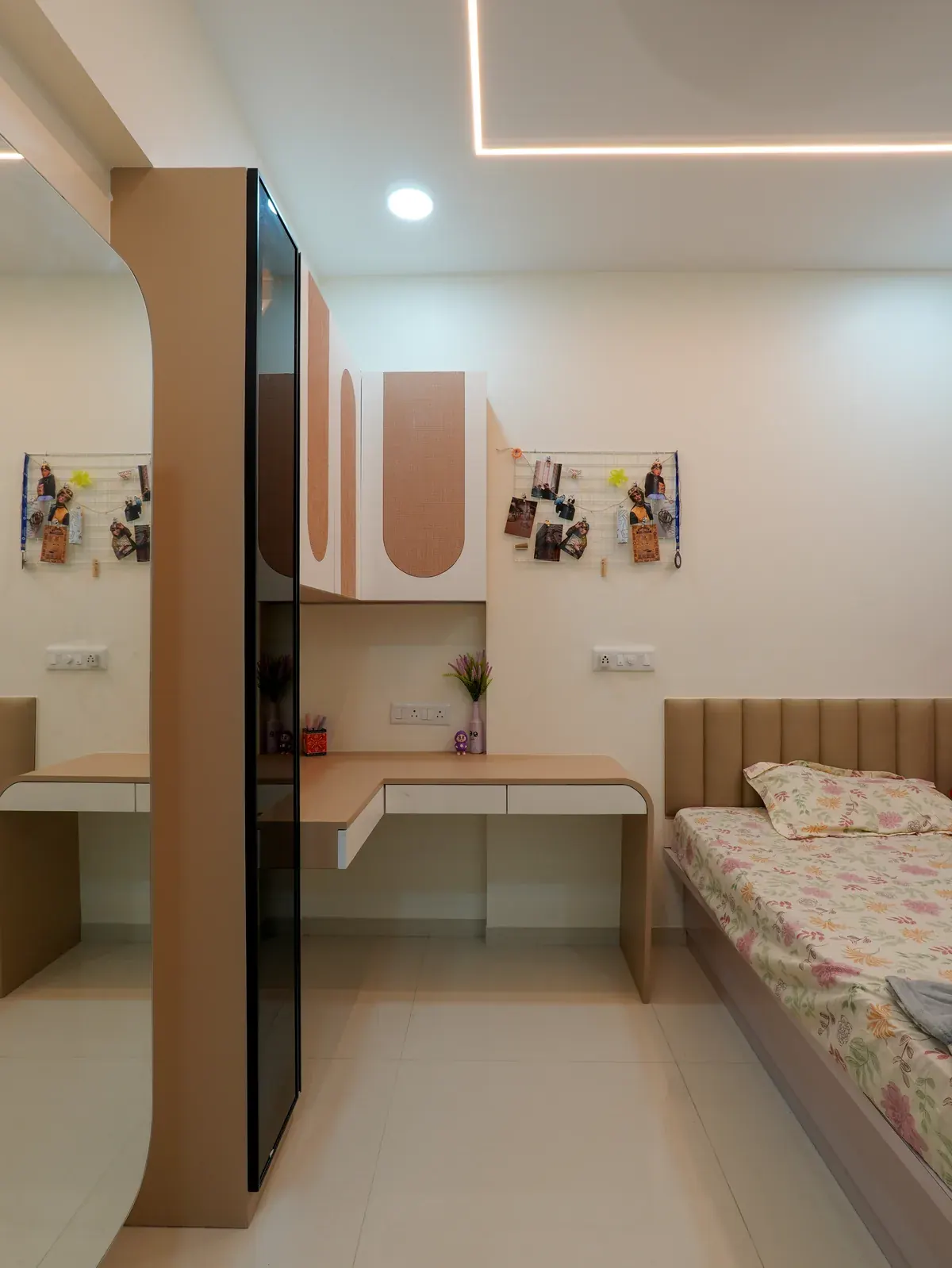 A fitted study nook, wall-mounted shelves and mirror integrated beside the bedroom wardrobe.